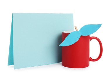 Photo of Happy Father's Day. Cup with mustache and blank card isolated on white