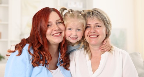 Photo of Grandmother, her daughter and granddaughter at home