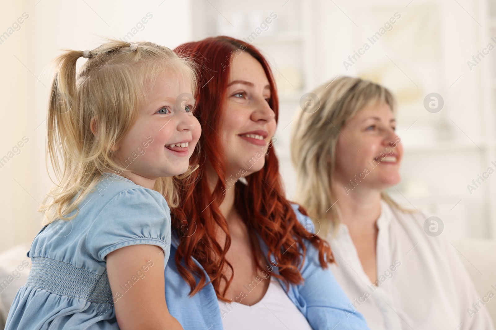 Grandmother, her daughter and granddaughter at home, selective focus Photo of Grandmother, her daughter and granddaughter at home, selective focus