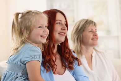 Photo of Grandmother, her daughter and granddaughter at home, selective focus