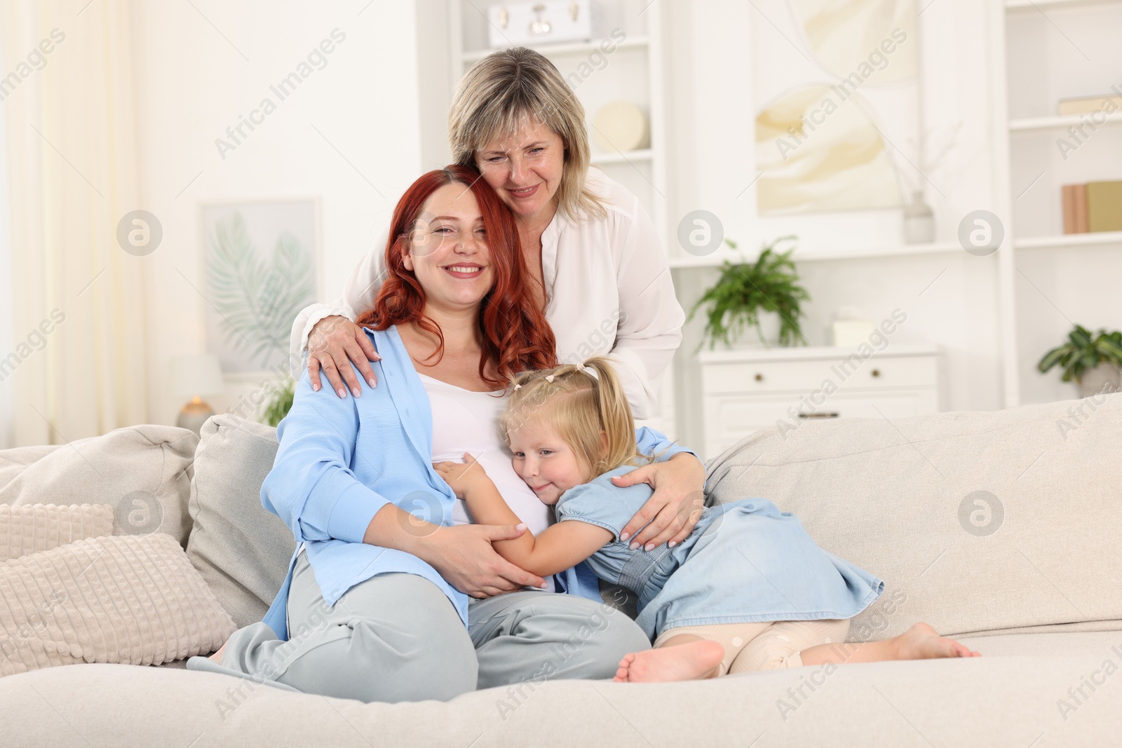 Pregnant woman, her mother and daughter at home Photo of Pregnant woman, her mother and daughter at home