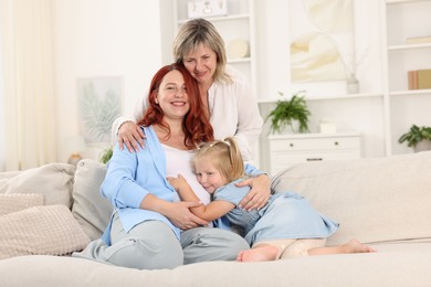 Photo of Pregnant woman, her mother and daughter at home