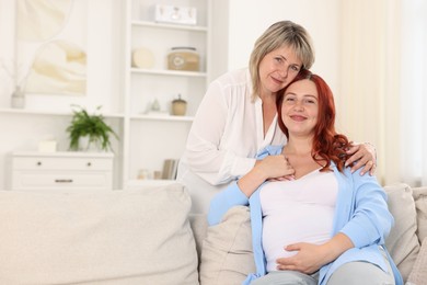 Photo of Pregnant woman and her mother at home