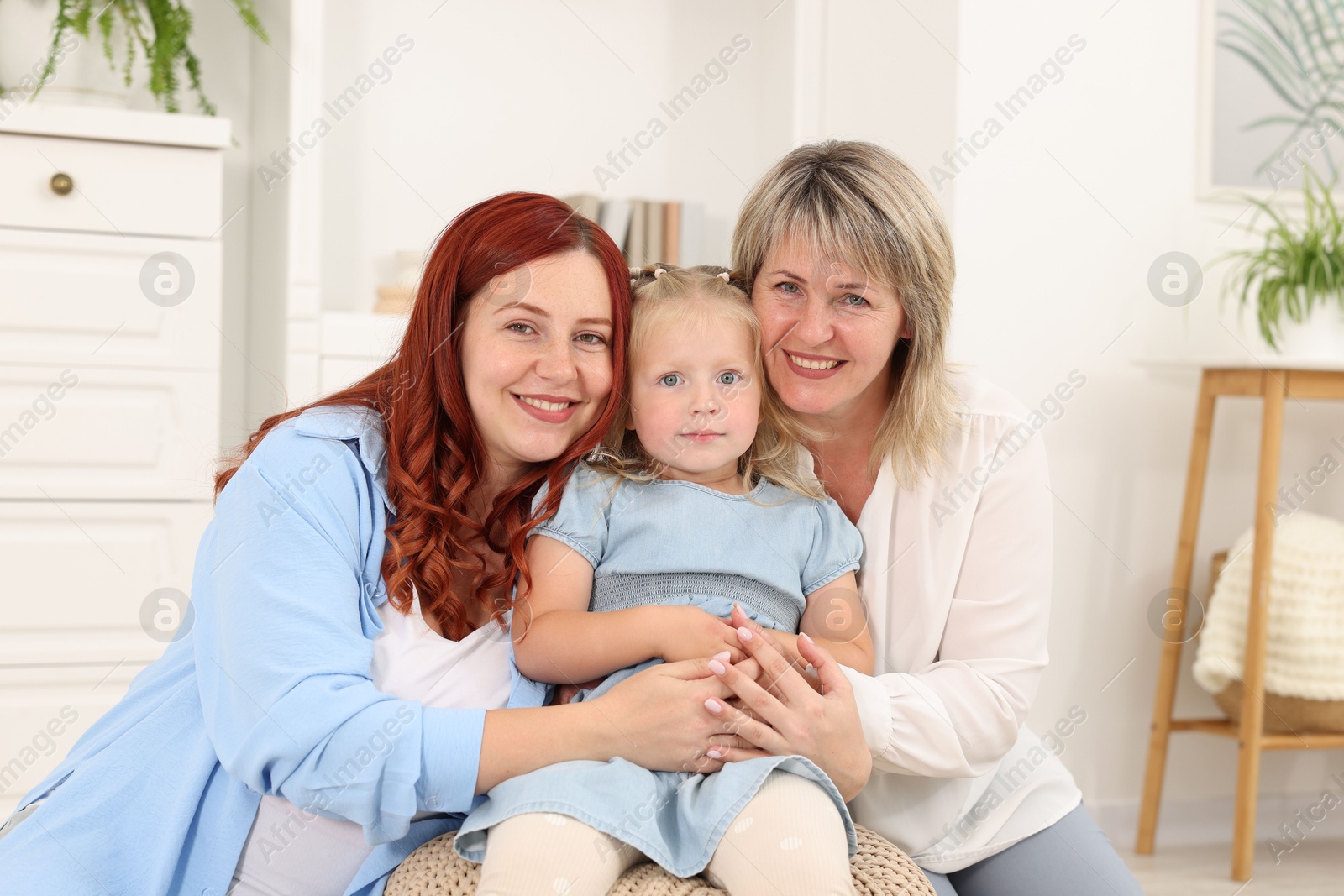 Pregnant woman, her mother and daughter at home Photo of Pregnant woman, her mother and daughter at home