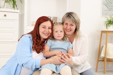 Photo of Pregnant woman, her mother and daughter at home