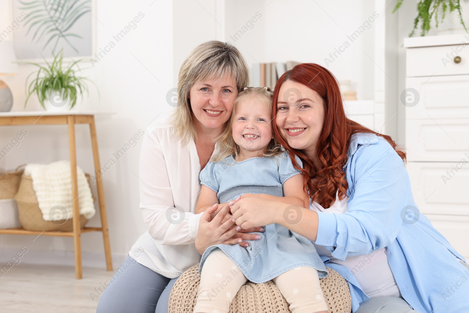 Pregnant woman, her mother and daughter at home Photo of Pregnant woman, her mother and daughter at home