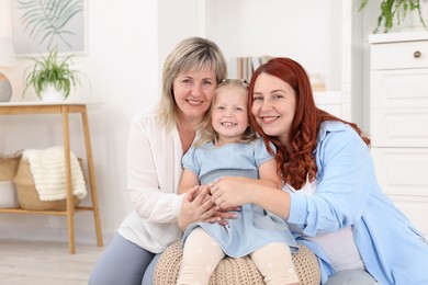 Photo of Pregnant woman, her mother and daughter at home