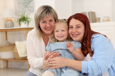 Photo of Grandmother, her daughter and granddaughter at home