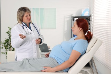 Photo of Pregnant woman having appointment with doctor in clinic
