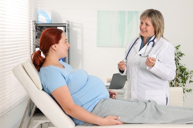 Photo of Pregnant woman having appointment with doctor in clinic