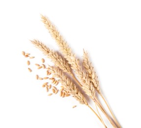 Photo of Many dried wheat ears and seeds isolated on white, top view