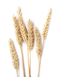 Photo of Many dried wheat ears isolated on white, top view