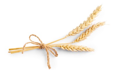 Photo of Bunch of dried wheat ears isolated on white, top view