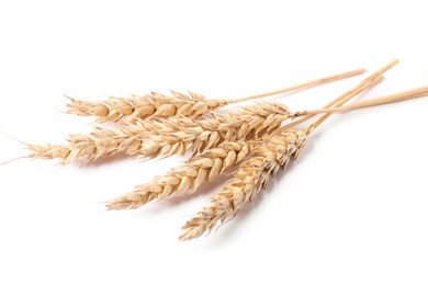Photo of Many dried wheat ears isolated on white