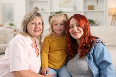 Photo of Grandmother, her daughter and granddaughter at home