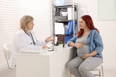 Photo of Pregnant woman having appointment with doctor in clinic