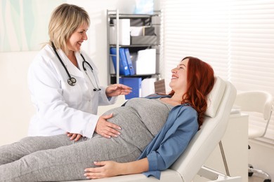 Photo of Pregnant woman having appointment with doctor in clinic