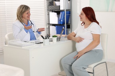 Photo of Pregnant woman having appointment with doctor in clinic