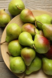 Photo of Fresh ripe pears on wooden table, flat lay
