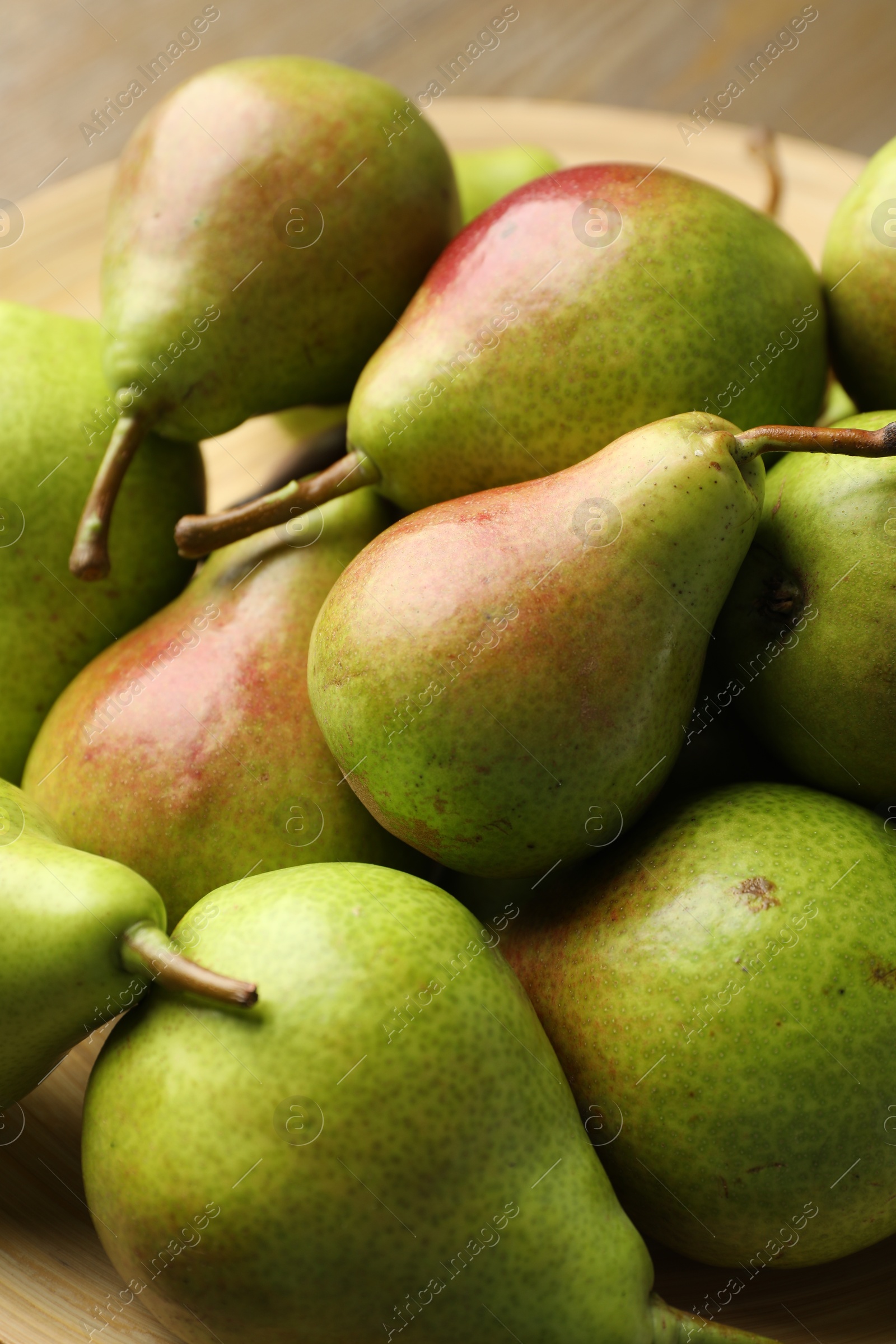 Photo of Many fresh ripe pears on plate, closeup