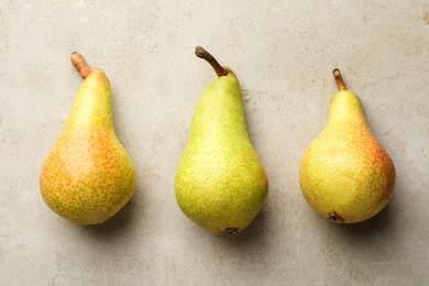 Photo of Fresh ripe pears on light grey table, flat lay