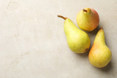 Photo of Fresh ripe pears on light grey table, flat lay. Space for text
