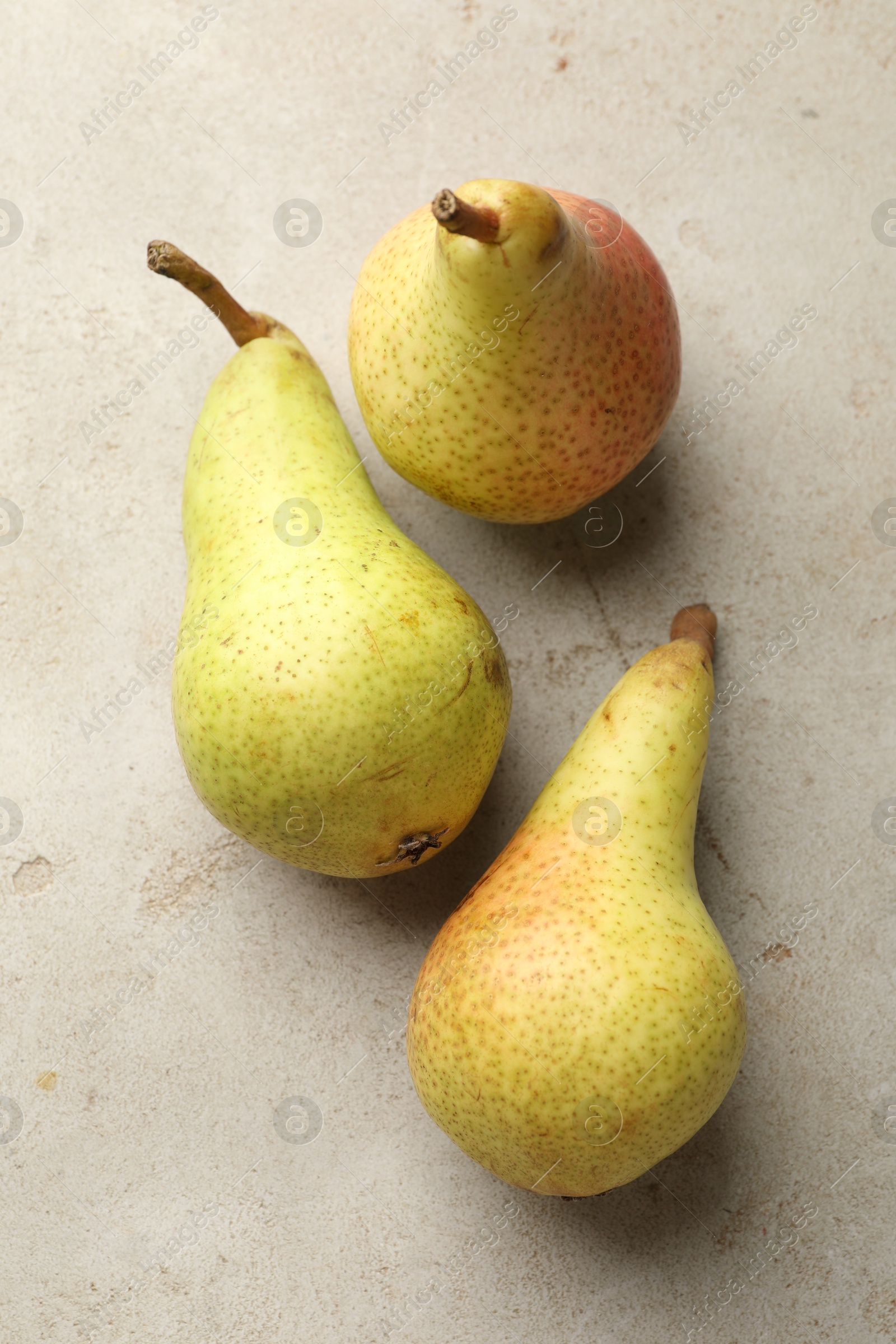 Photo of Fresh ripe pears on light grey table, flat lay