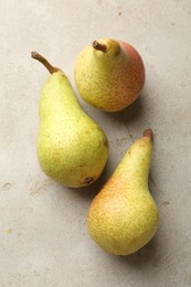 Photo of Fresh ripe pears on light grey table, flat lay
