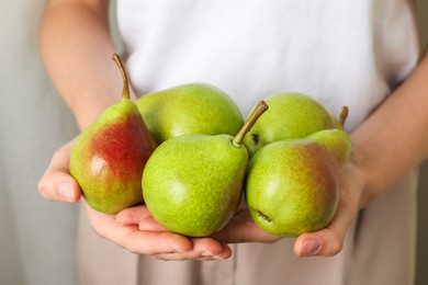Photo of Woman with fresh ripe pears indoors, closeup