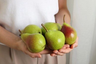 Photo of Woman with fresh ripe pears indoors, closeup