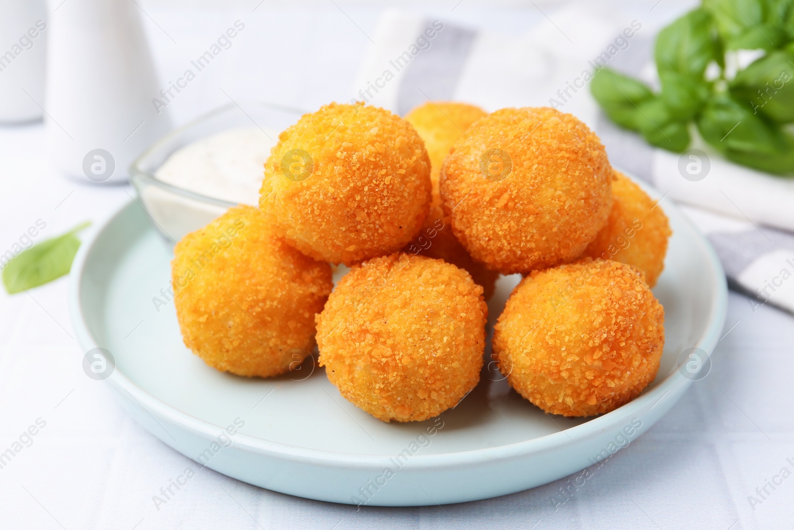 Delicious fried croquette balls on light tiled table, closeup Photo of Delicious fried croquette balls on light tiled table, closeup