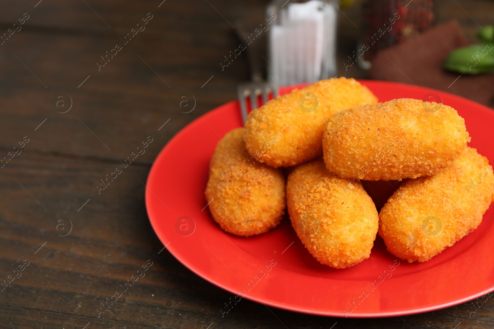Many delicious fried croquettes on wooden table, closeup Photo of Many delicious fried croquettes on wooden table, closeup