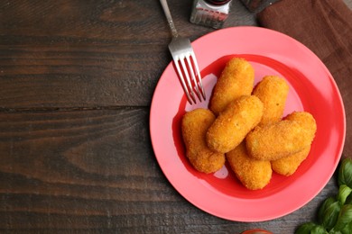 Photo of Delicious fried croquettes served on wooden table, flat lay. Space for text