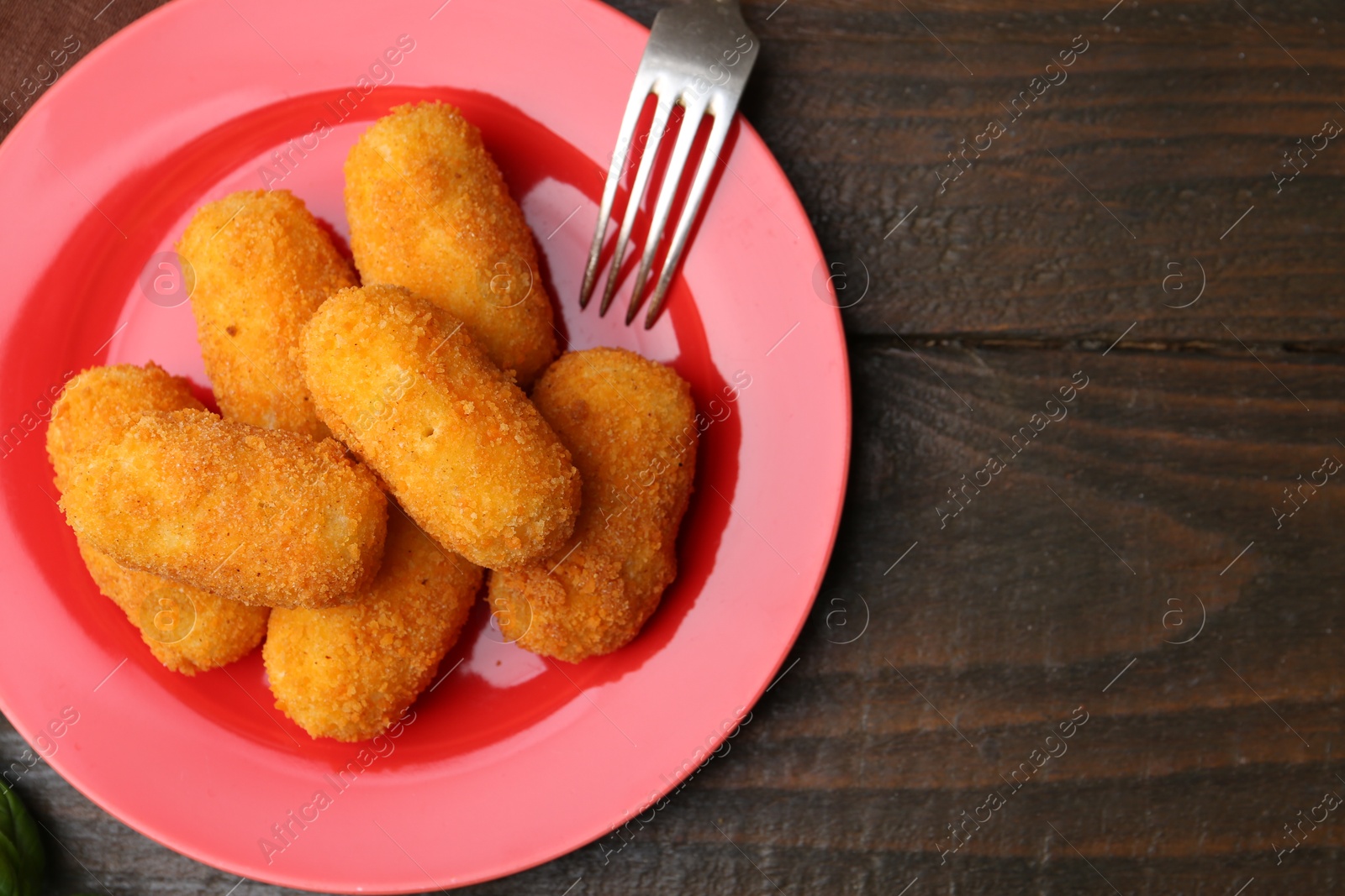 Delicious fried croquettes served on wooden table, flat lay Photo of Delicious fried croquettes served on wooden table, flat lay