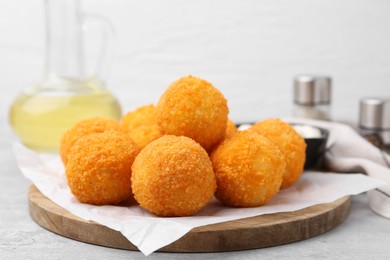 Photo of Delicious fried croquette balls on gray table, closeup