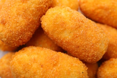 Photo of Delicious fried croquettes as background, top view