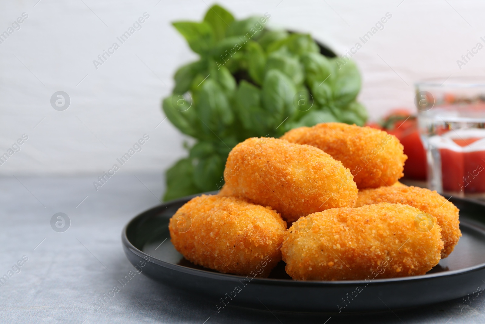 Delicious fried croquettes on gray table, closeup Photo of Delicious fried croquettes on gray table, closeup