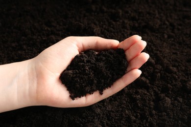 Photo of Woman with pile of fresh soil, closeup
