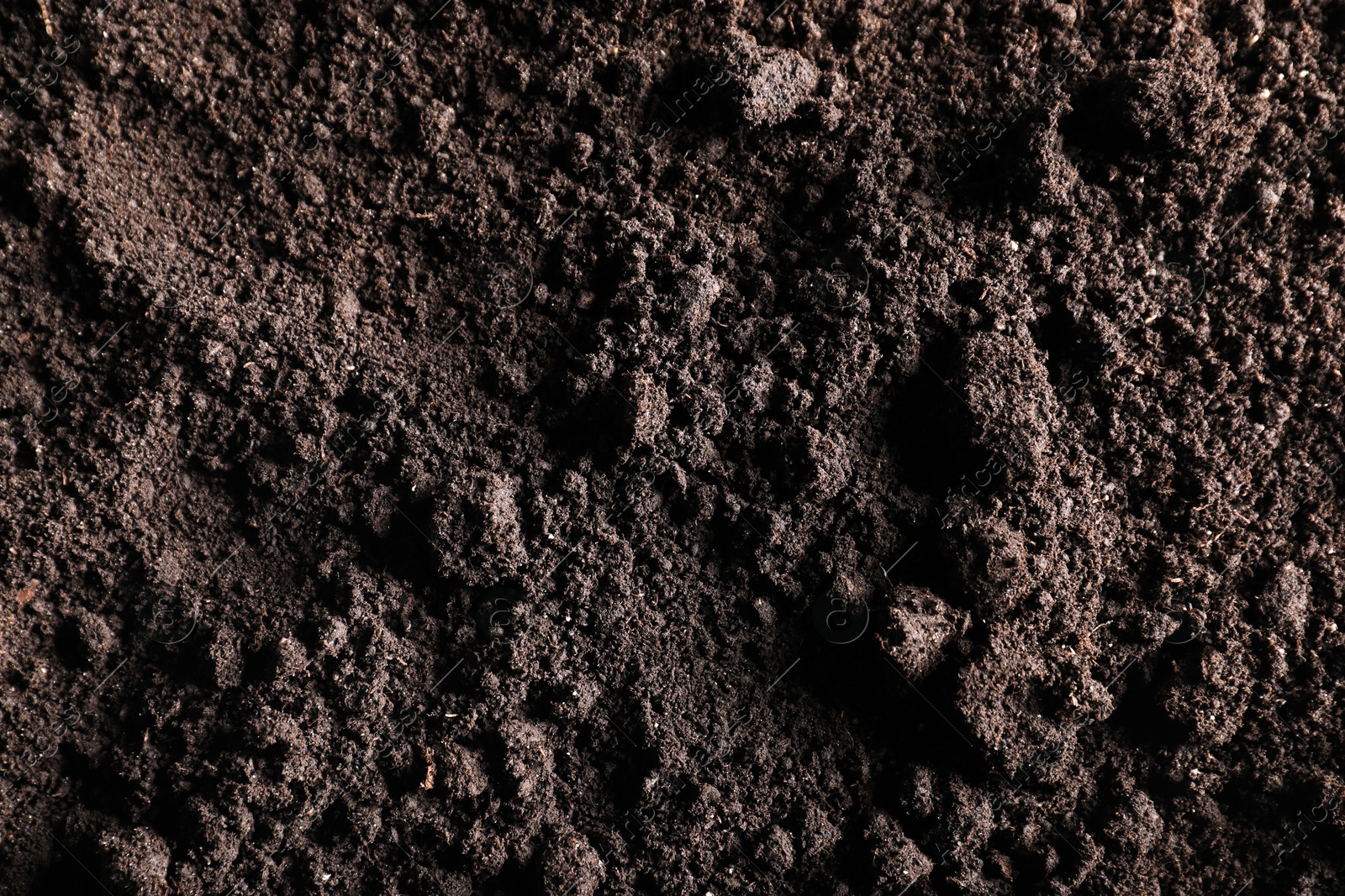 Photo of Fresh soil as background, top view. Organic matter