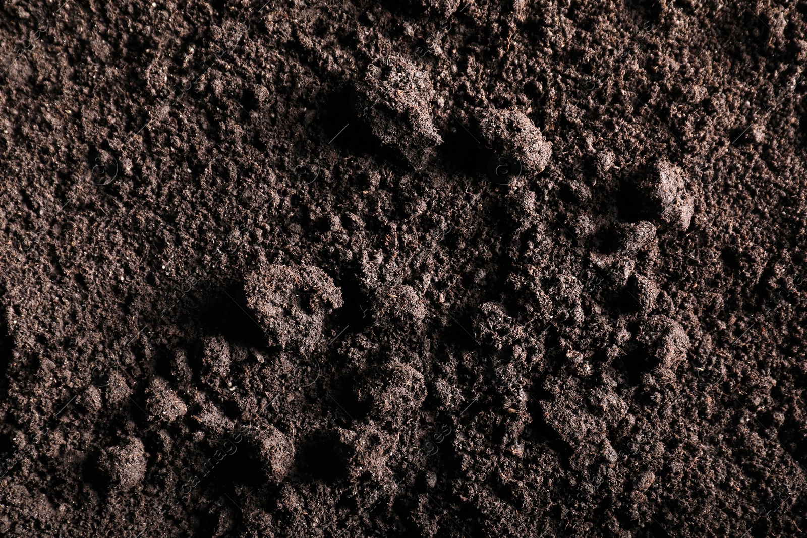 Photo of Fresh soil as background, top view. Organic matter