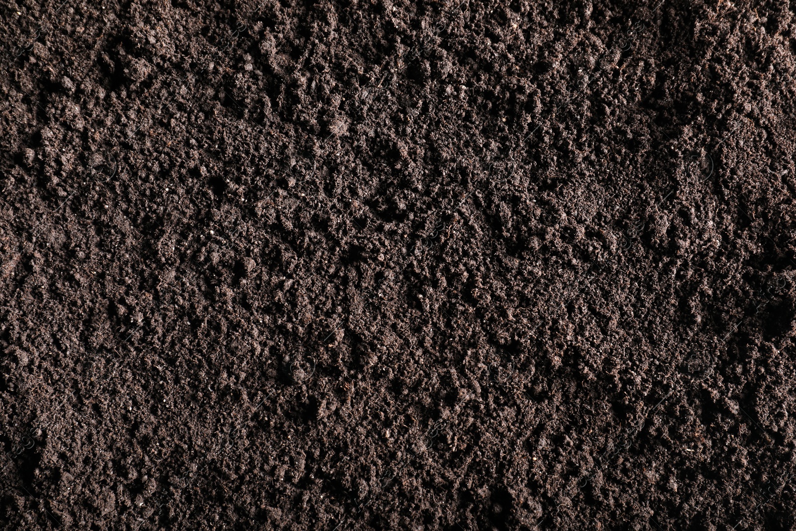 Photo of Fresh soil as background, top view. Organic matter