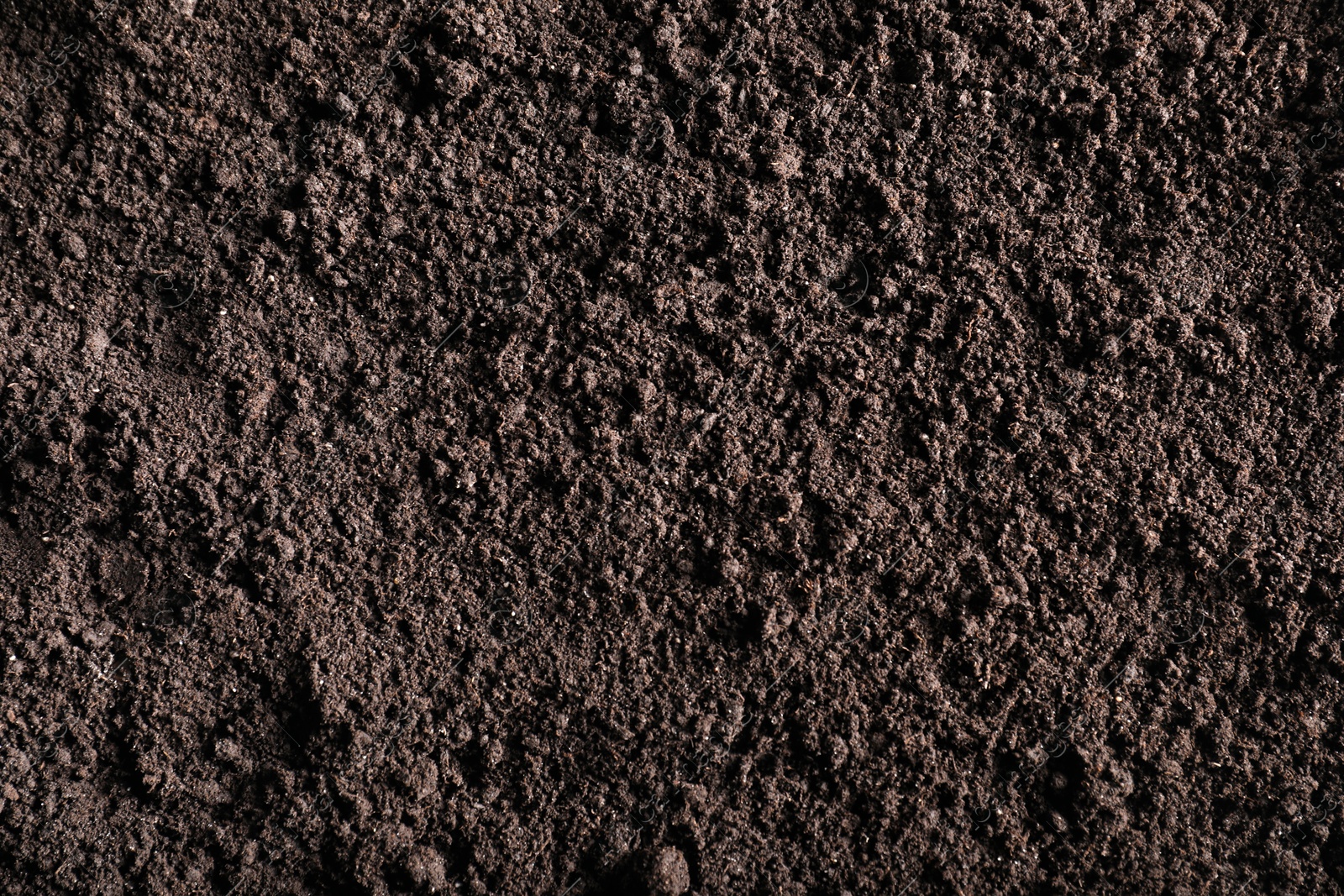 Photo of Fresh soil as background, top view. Organic matter