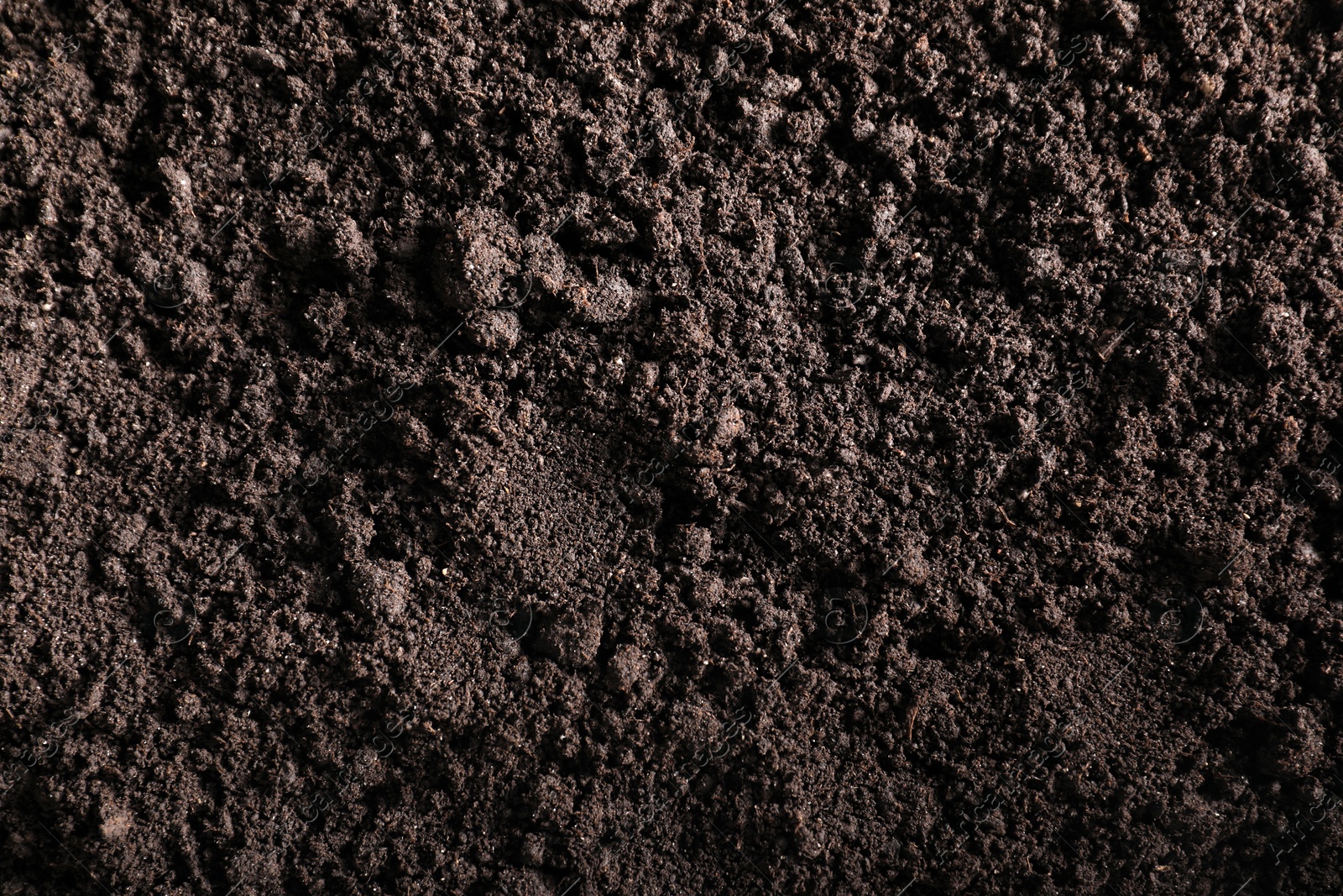 Photo of Fresh soil as background, top view. Organic matter