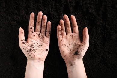 Photo of Woman with fresh soil, top view. Organic matter