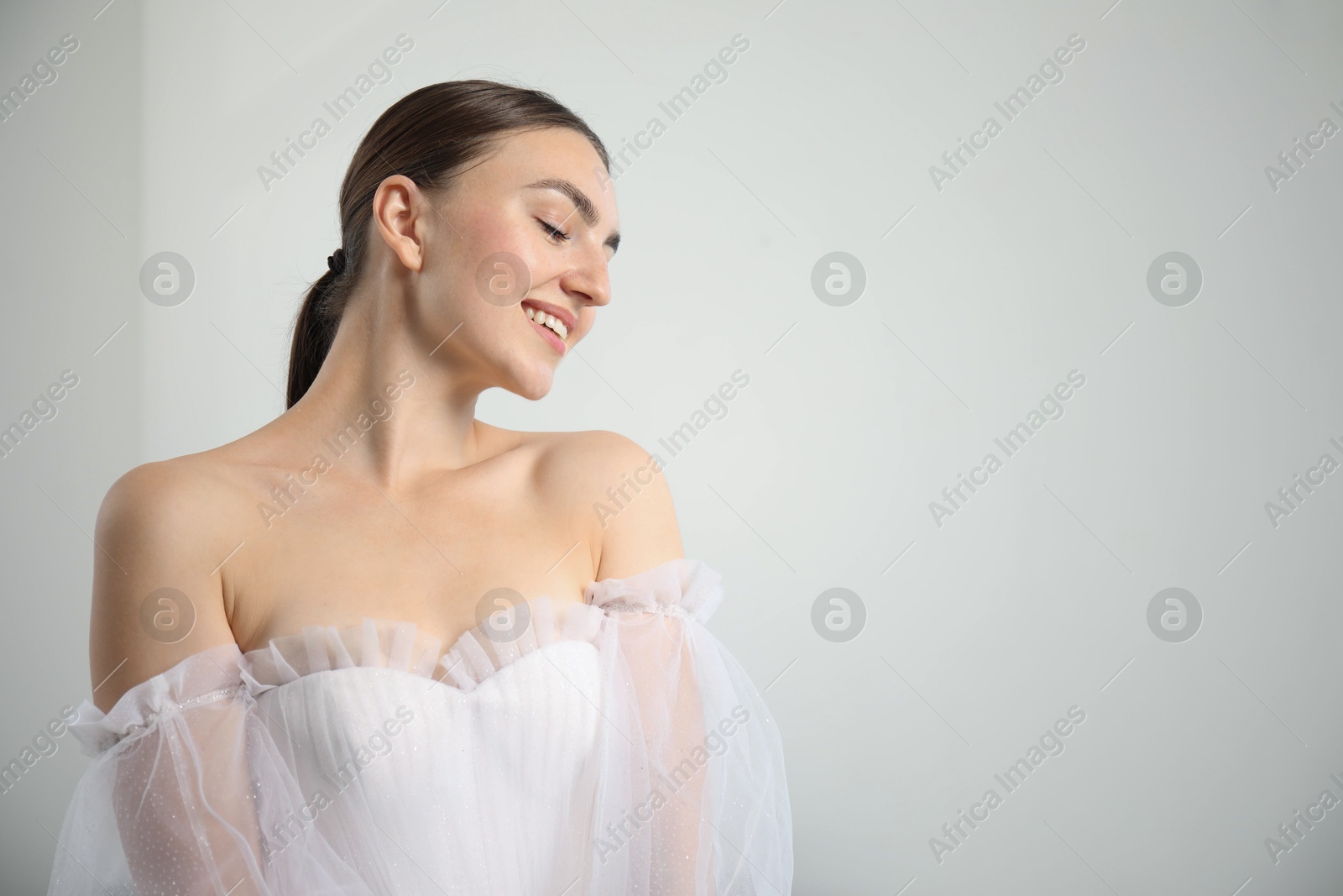 Dreams come true. Woman in beautiful wedding dress at home, space for text Photo of Dreams come true. Woman in beautiful wedding dress at home, space for text