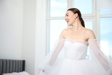 Photo of Dreams come true. Woman in beautiful wedding dress at home, space for text