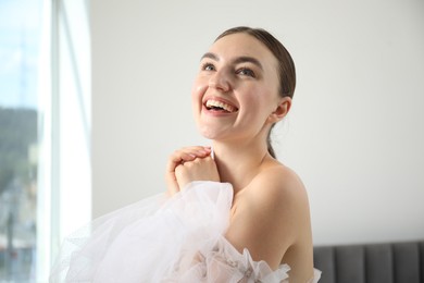 Photo of Dreams come true. Woman in beautiful wedding dress at home