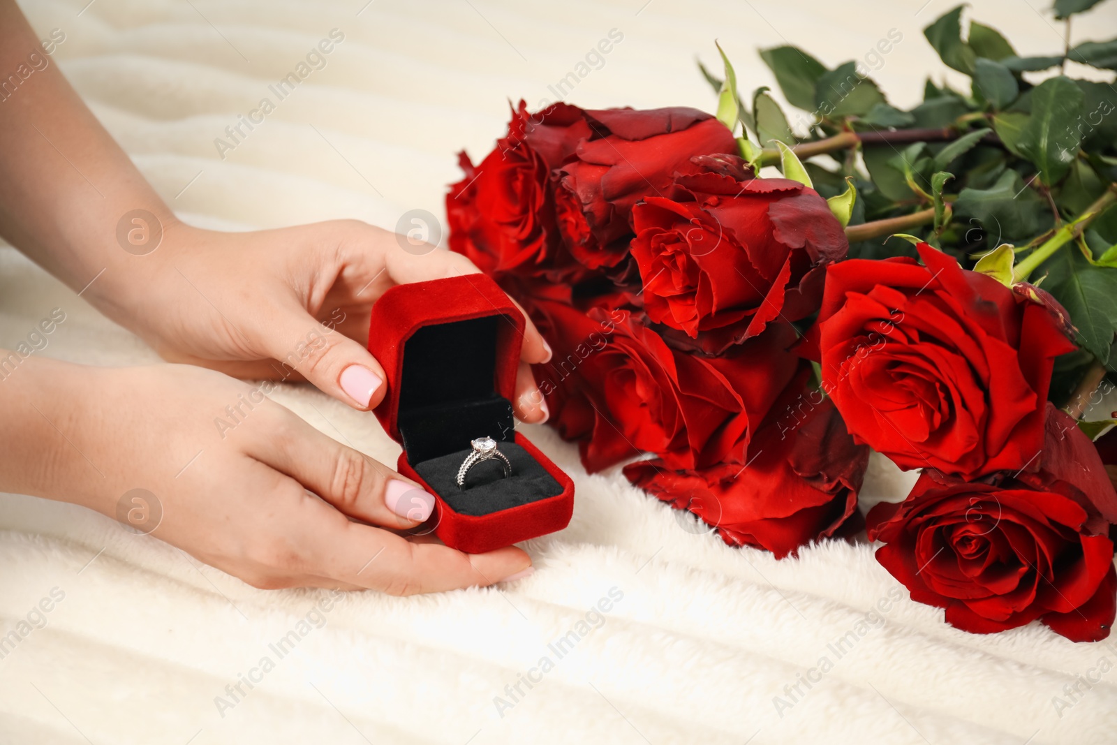 Photo of Dreams come true. Happy woman with engagement ring and beautiful bouquet indoors, closeup