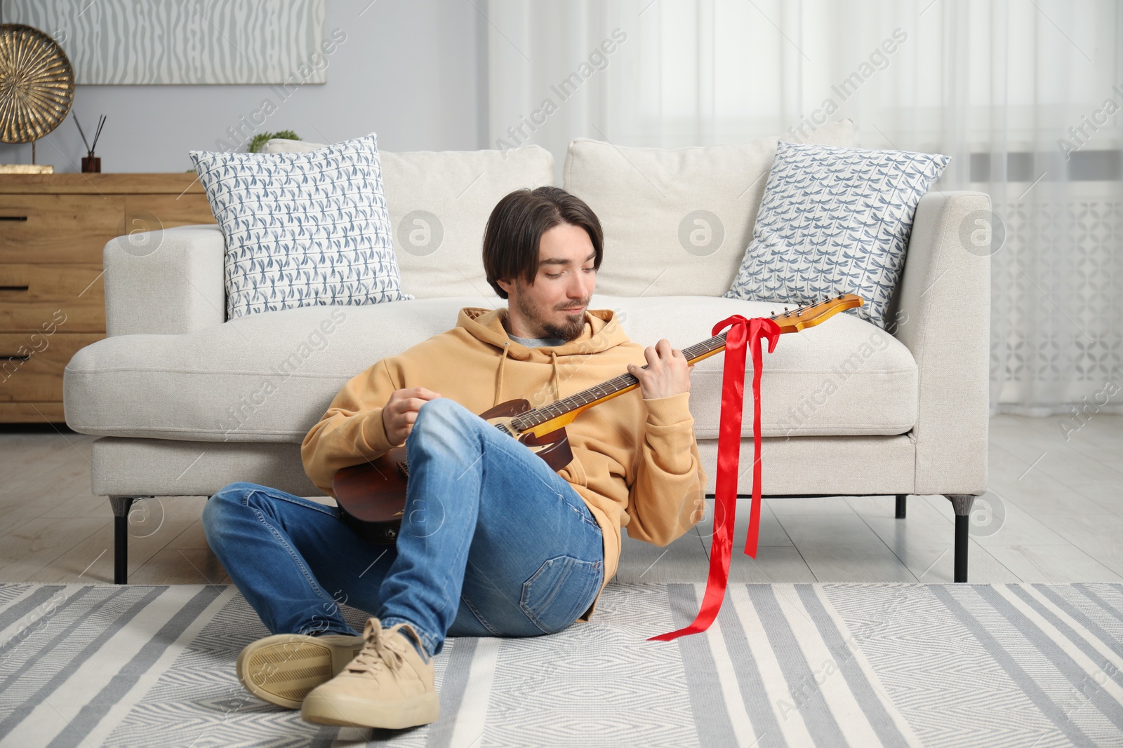Dreams come true. Happy man with guitar at home Photo of Dreams come true. Happy man with guitar at home