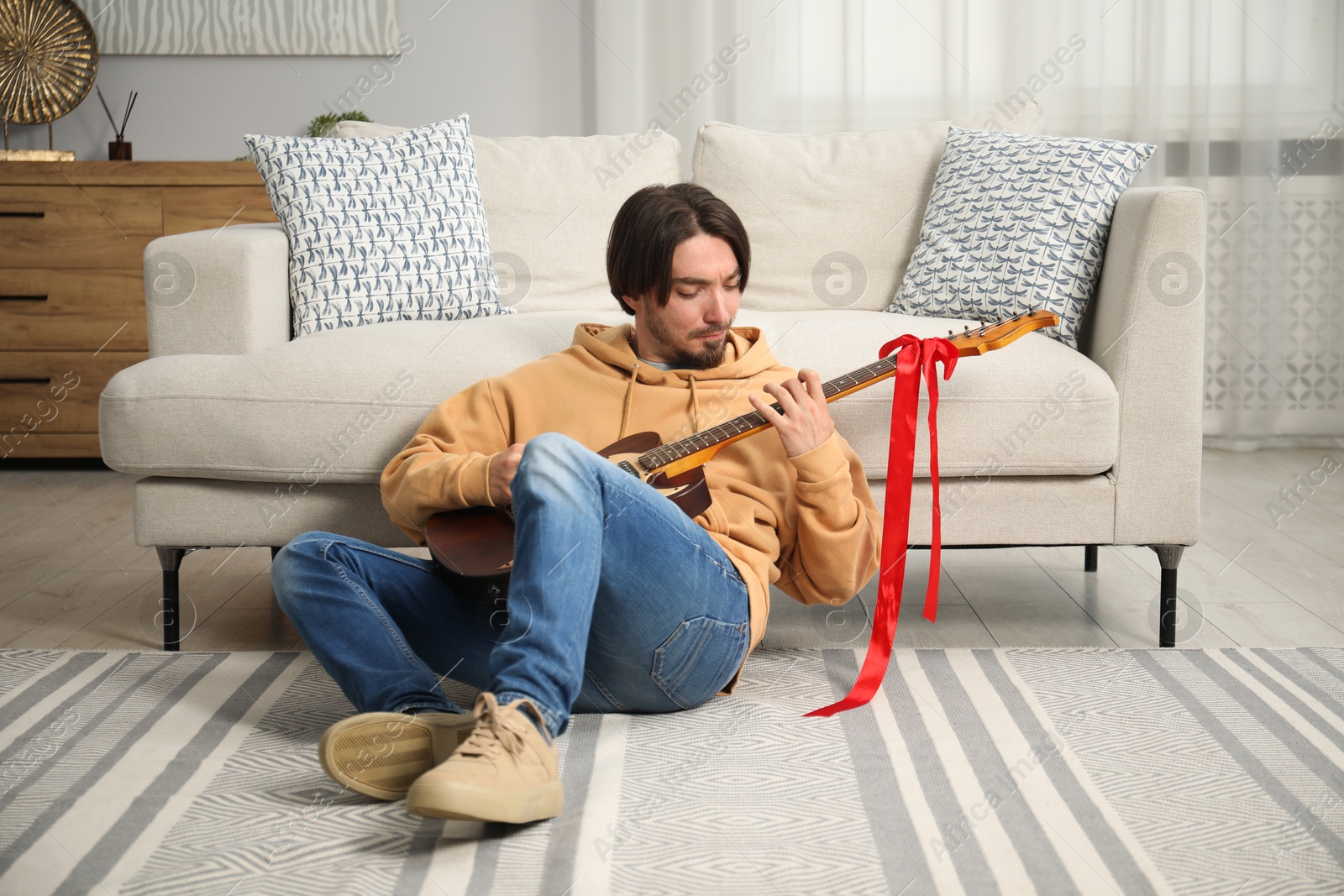Dreams come true. Happy man with guitar at home Photo of Dreams come true. Happy man with guitar at home